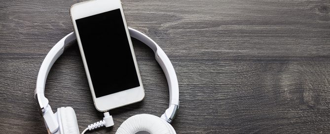 headphones and phone on wood background