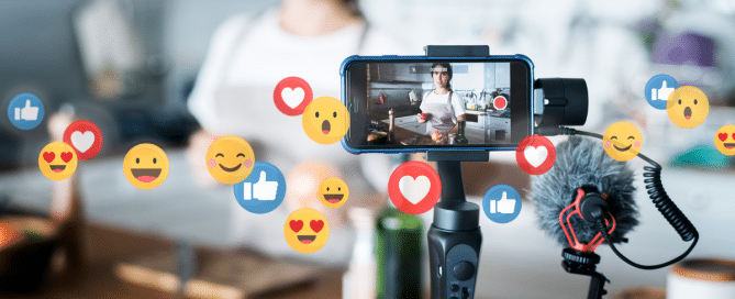 person at desk behind camera with social icons floating around