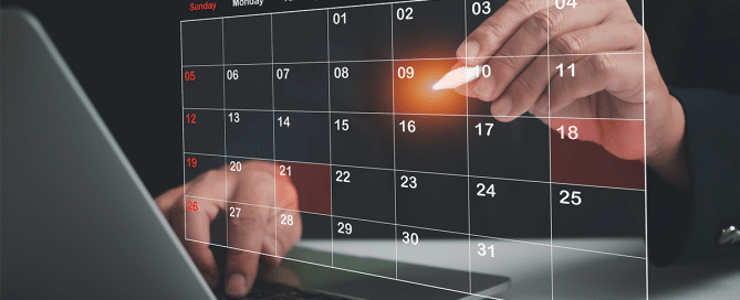 person's hands working on laptop and virtual translucent calendar