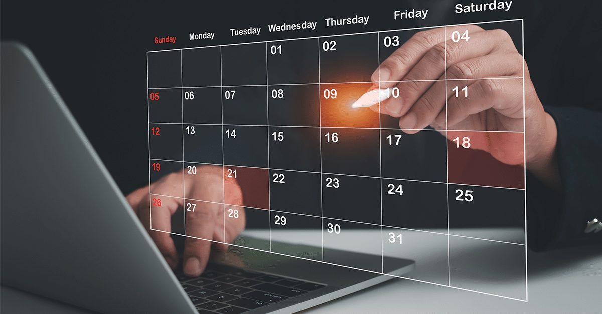 person's hands working on laptop and virtual translucent calendar