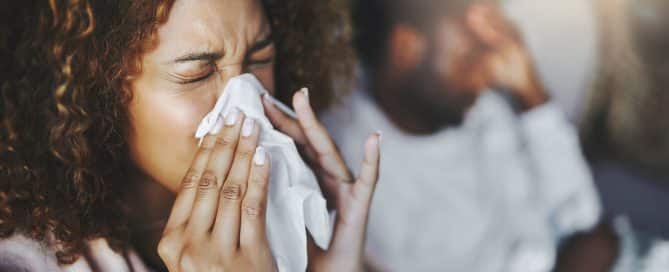 woman blowing nose